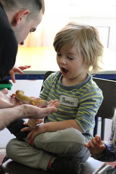 child in animal workshop looking happy at north london day camp for kids