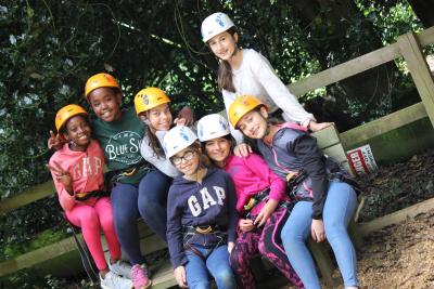 smiley happy kids at summer camp uk wearing helmets