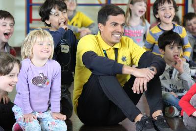 smiley summer camp staff with cute children london