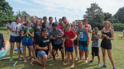 summer school students having a water fight at english summer school london