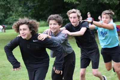 teenage boys playing games at summer camp in england