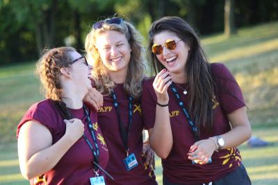 Summer camp staff laughing having fun holiday job