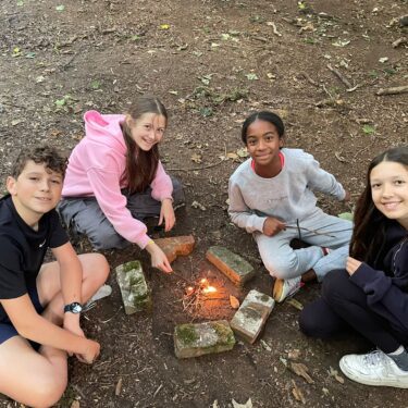 Campers around the camp fire at international summer camps UK