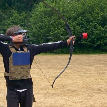 Boy doing Archery at XUK summer camps in uk