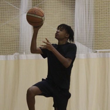 Teen playing basketball at XUK Camps which Fosters Emotional Intelligence in Children