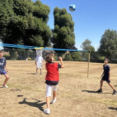 Boys being active playing sports at health summer camps