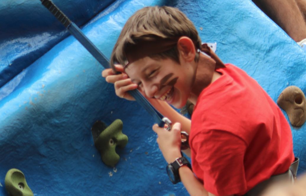 Happy Camper on climbing wall at Summer School UK